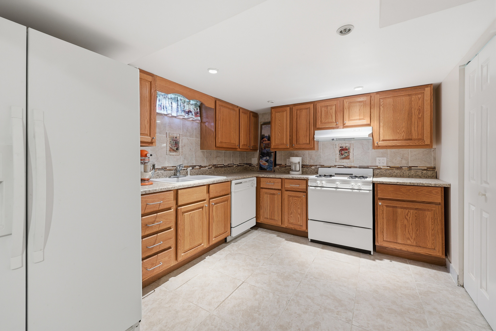329 East Myrick Avenue Addison, IL 60101 - Photo 21 of 30 a kitchen with white cabinets sink and white appliances