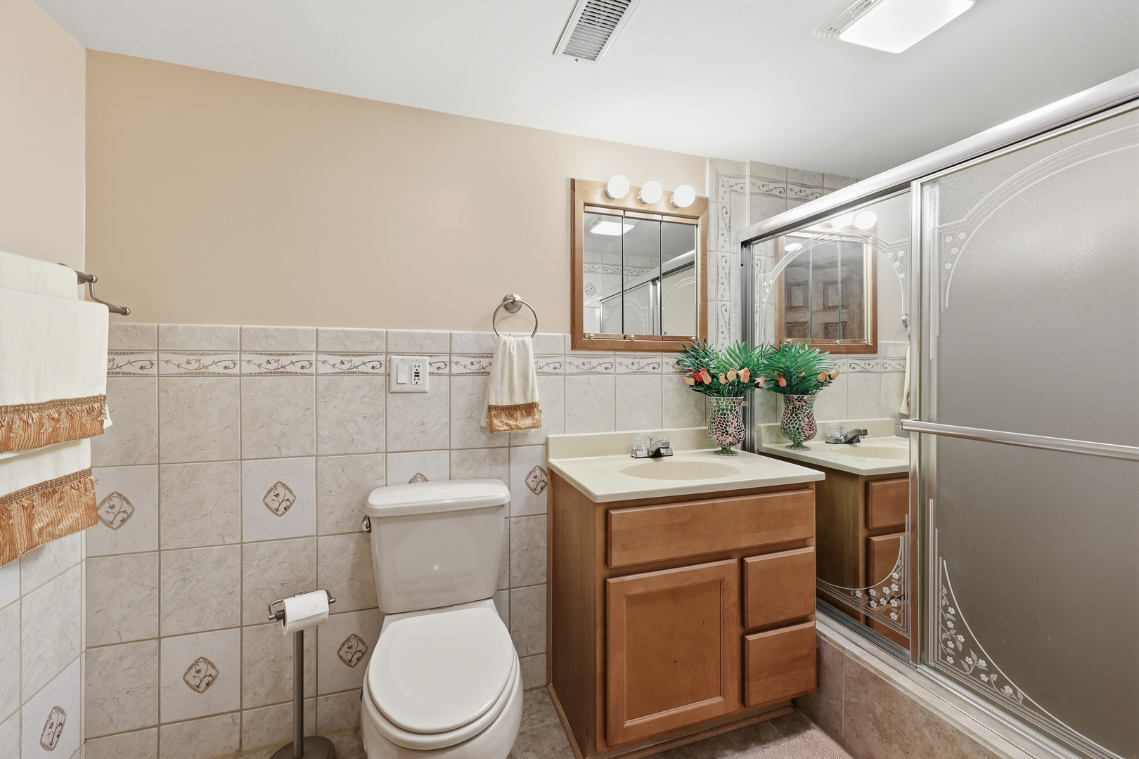 329 East Myrick Avenue Addison, IL 60101 - Photo 22 of 30 a bathroom with a toilet sink vanity and mirror