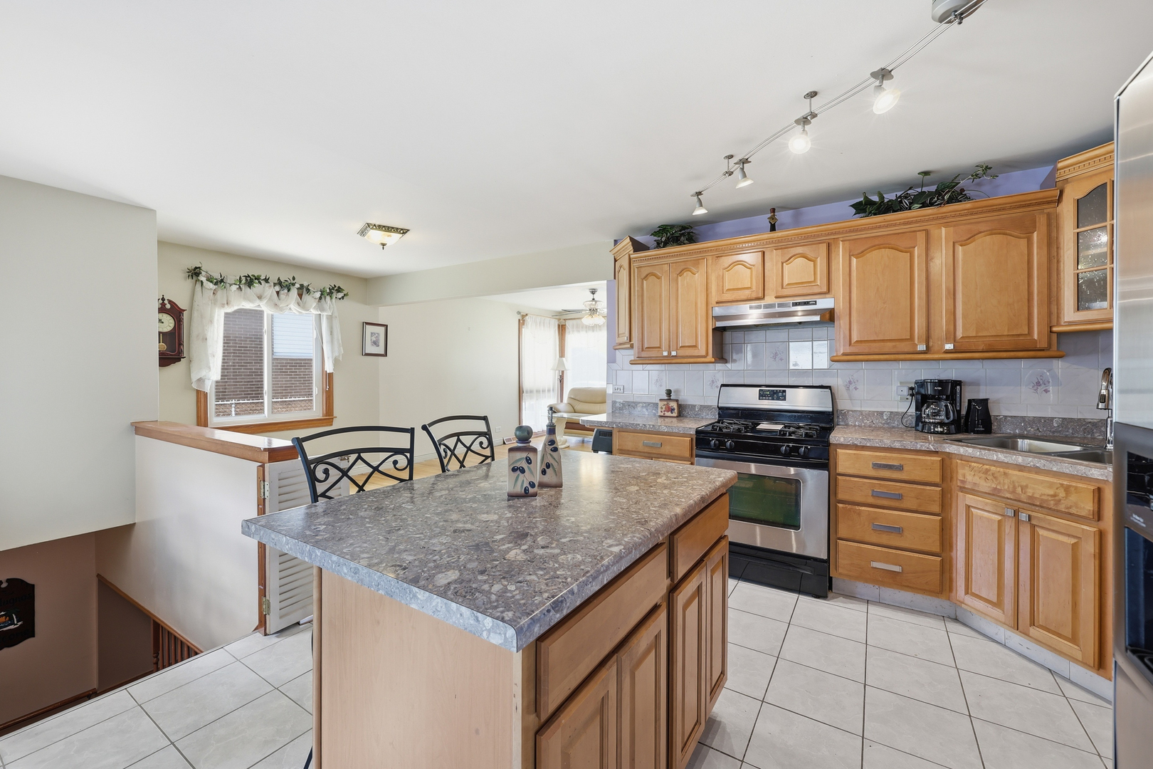 329 East Myrick Avenue Addison, IL 60101 - Photo 3 of 30 a kitchen with stainless steel appliances granite countertop a stove top oven a sink dishwasher and cabinets with wooden floor