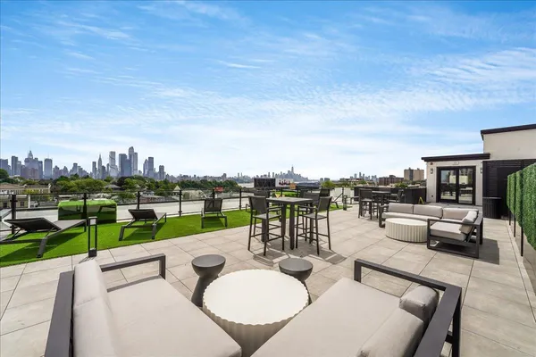 a view of a terrace with furniture and a fire pit