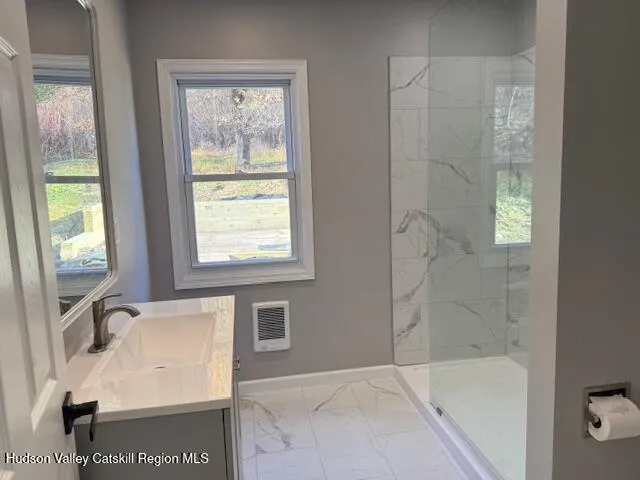 a bathroom with a sink toilet and shower