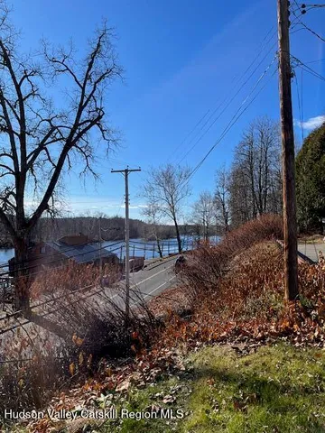 a view of a backyard with a table and chairs under an umbrella