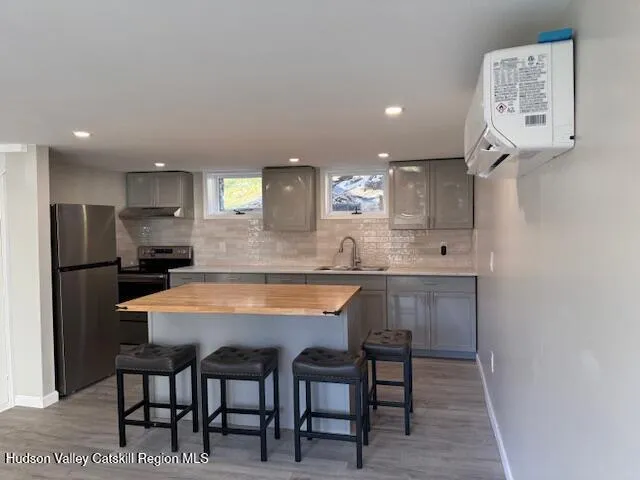 a large kitchen with a table and chairs