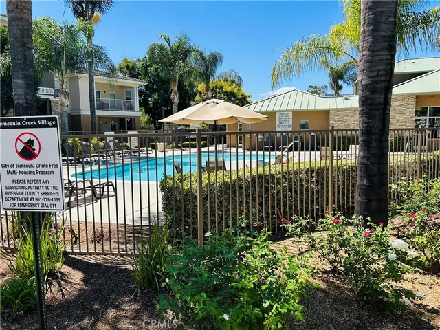 a view of a house with a garden and pathway