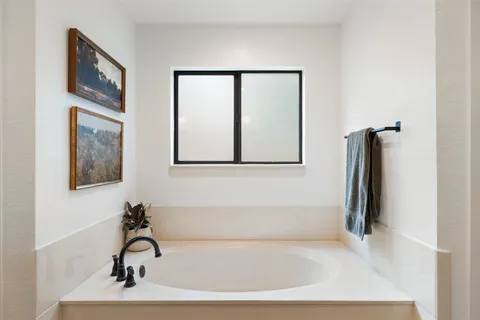 a bathroom with a bathtub and a shower