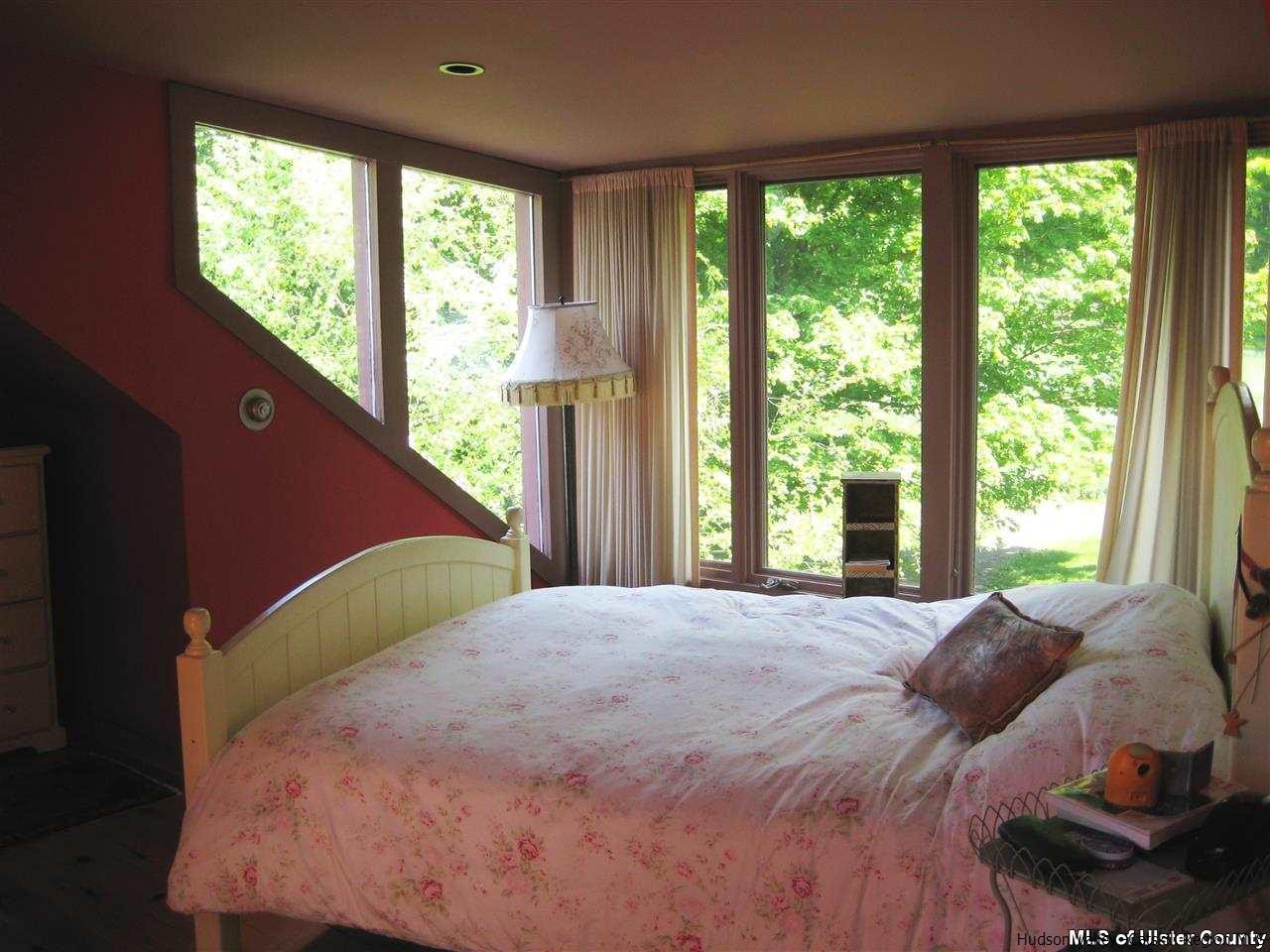 17 Cross Patch Road Woodstock, NY 12495 - Photo 19 of 35 a large bedroom with a bed and a large window
