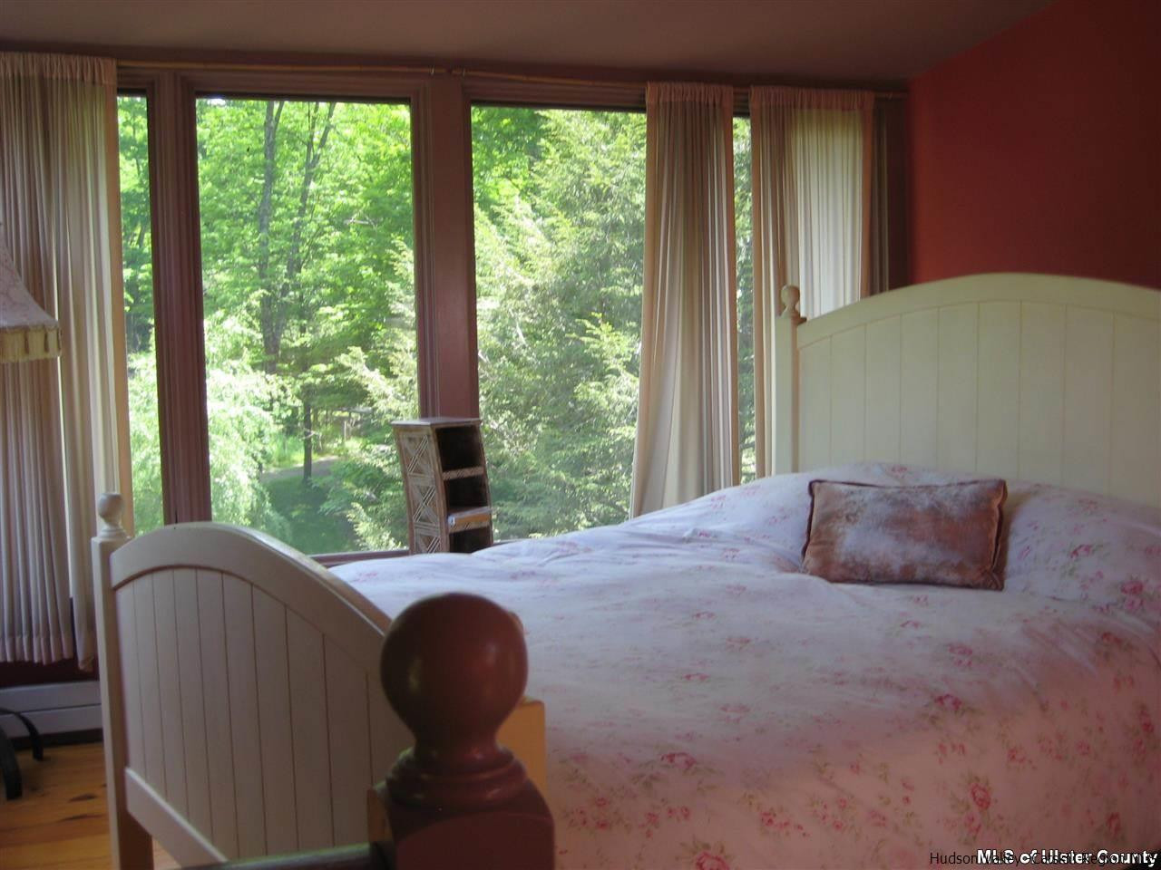 17 Cross Patch Road Woodstock, NY 12495 - Photo 20 of 35 a bedroom with a bed and windows