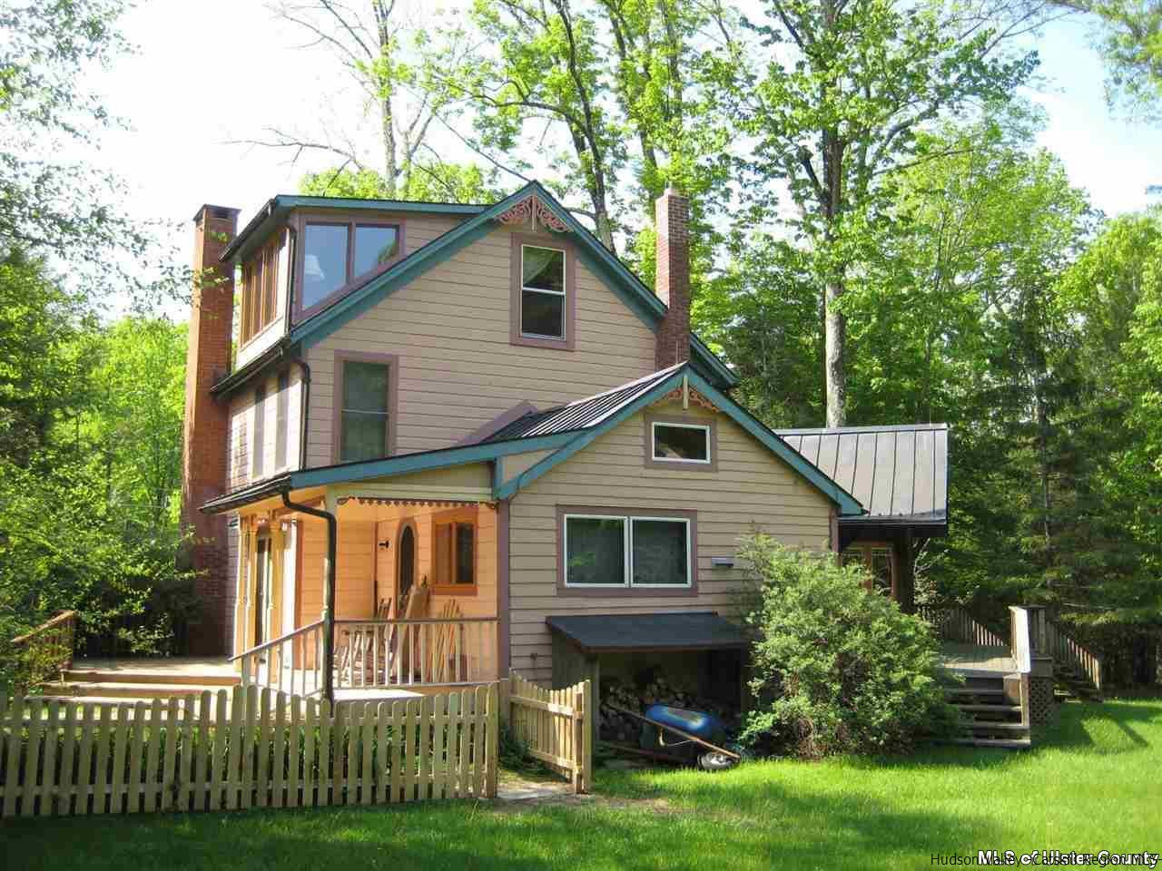 17 Cross Patch Road Woodstock, NY 12495 - Photo 2 of 35 a front view of a house with a garden and plants