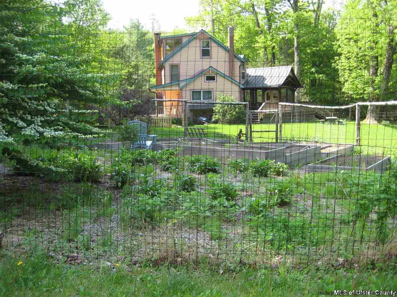 17 Cross Patch Road Woodstock, NY 12495 - Photo 3 of 35 a front view of a house with a yard and potted plants