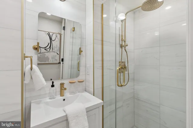 a bathroom with a shower sink and mirror