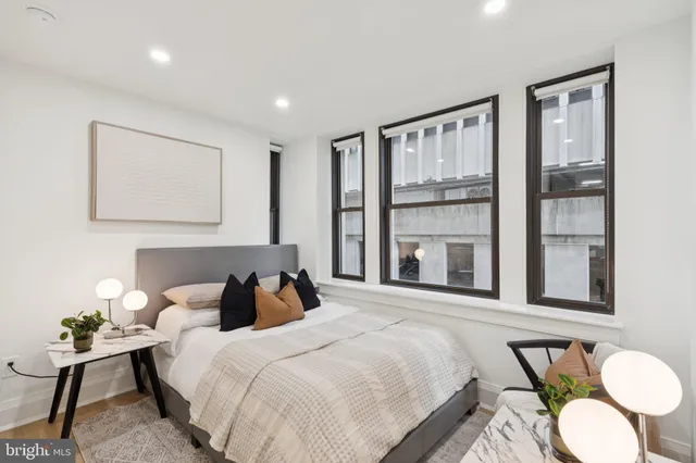 a bedroom with bed and windows