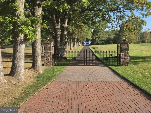 a view of a park with iron fence