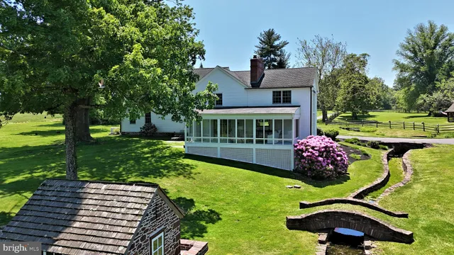 a dining hall with stainless steel appliances kitchen island granite countertop furniture and wooden floor