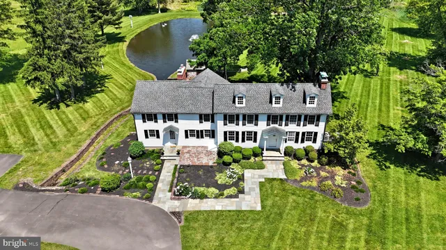 an aerial view of a house with garden space and sitting area