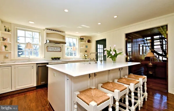 a dining room with furniture water view and large windows