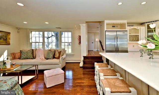 a view of staircase with white walls and a painting