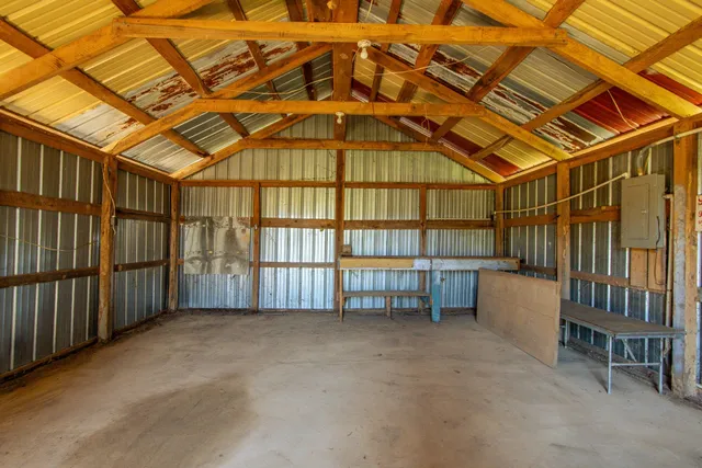 an empty room with a window and a ceiling fan