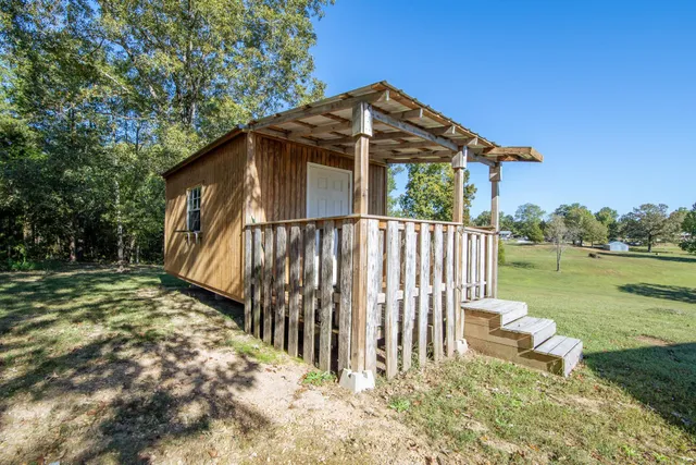 a backyard of a house with a small yard and wooden fence
