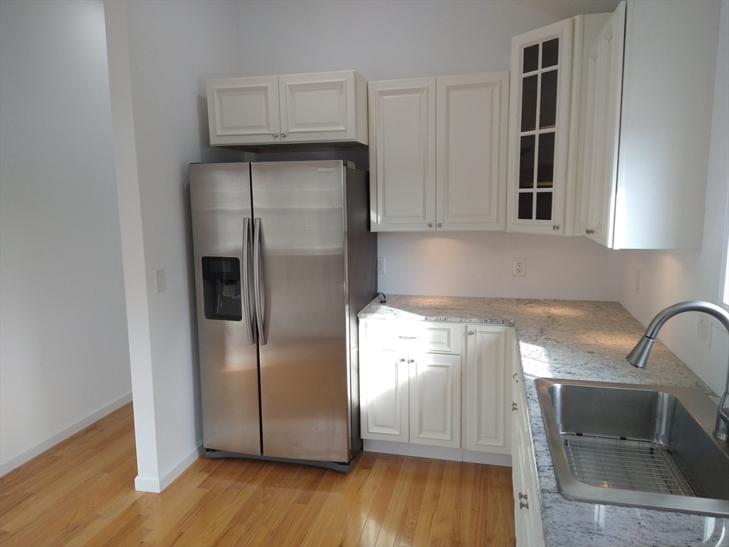 26 Russell Street, Unit AB Hadley, MA 01035 - Photo 14 of 42 a kitchen with a refrigerator sink and cabinets