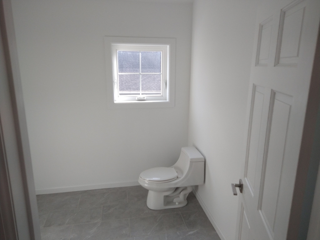 26 Russell Street, Unit AB Hadley, MA 01035 - Photo 15 of 42 a white toilet sitting next to a bathroom sink