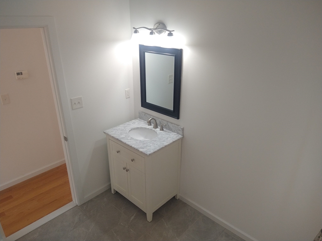 26 Russell Street, Unit AB Hadley, MA 01035 - Photo 16 of 42 a bathroom with a sink vanity and mirror