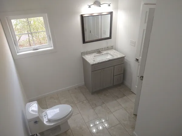 with view of a small space with wooden floor and windows