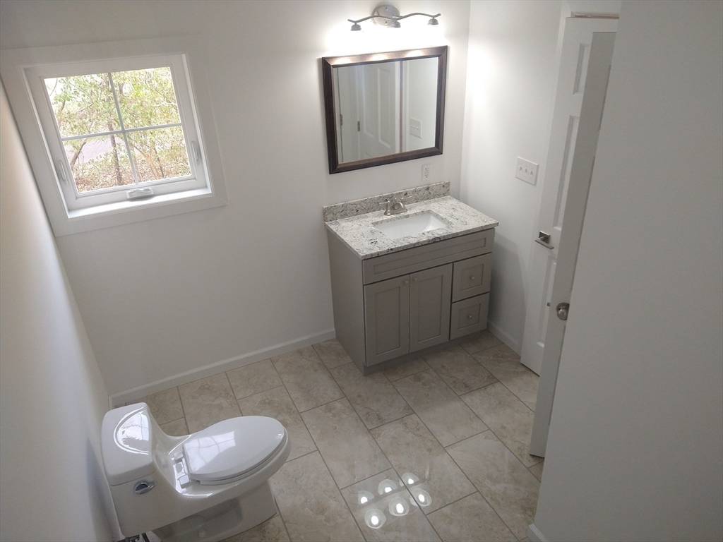 26 Russell Street, Unit AB Hadley, MA 01035 - Photo 22 of 42 a bathroom with a granite countertop sink and a mirror