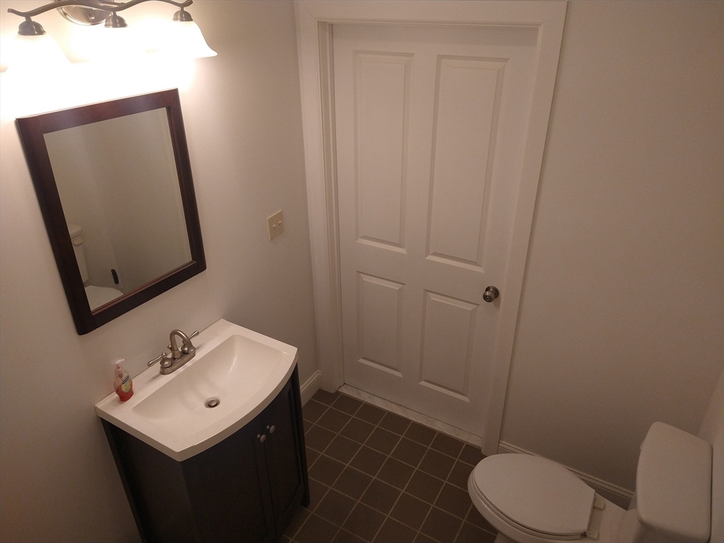 26 Russell Street, Unit AB Hadley, MA 01035 - Photo 28 of 42 a bathroom with a sink toilet and mirror