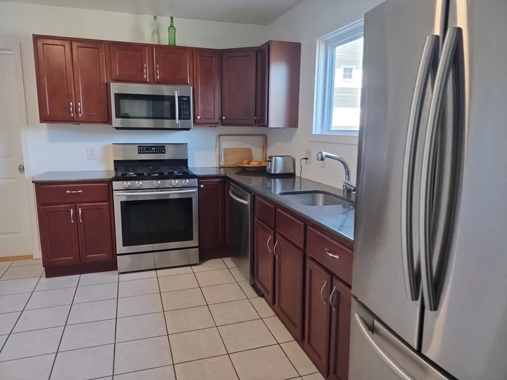 26 Russell Street, Unit AB Hadley, MA 01035 - Photo 31 of 42 a kitchen with stainless steel appliances granite countertop a refrigerator and a stove top oven