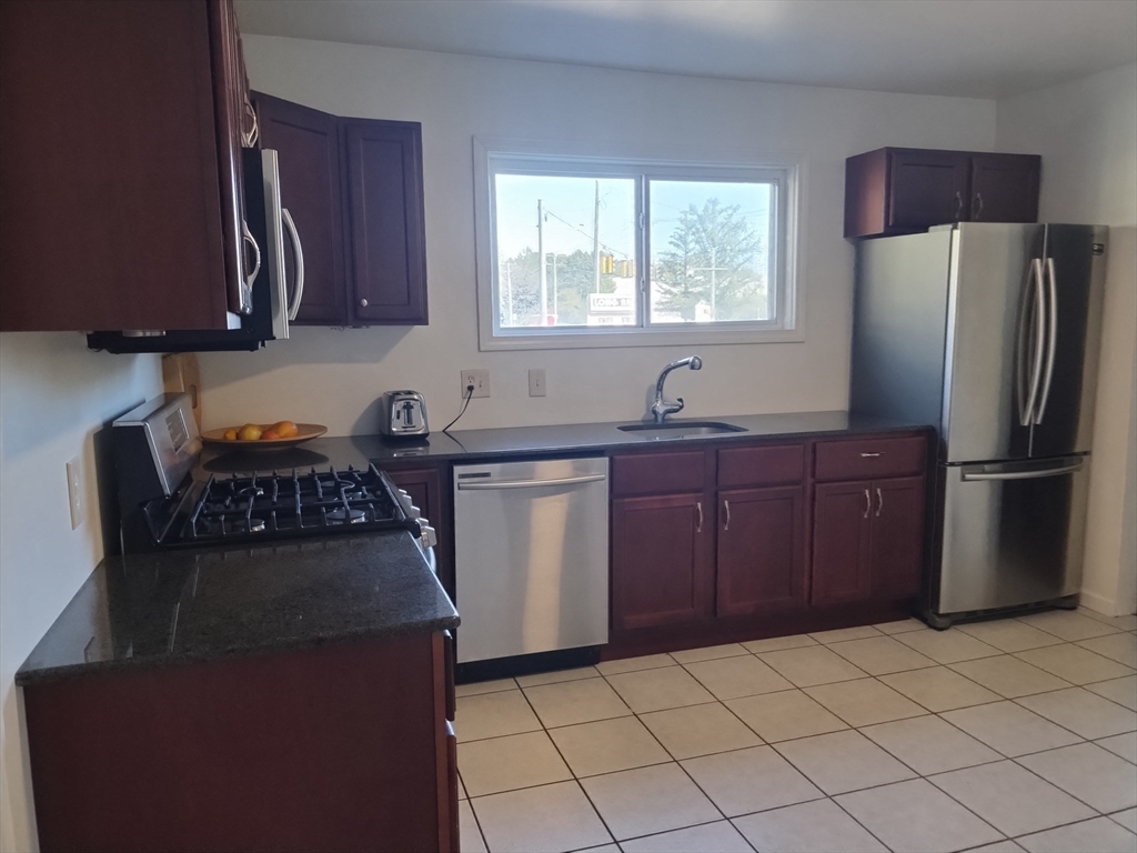 26 Russell Street, Unit AB Hadley, MA 01035 - Photo 32 of 42 a kitchen with stainless steel appliances granite countertop a refrigerator stove and sink