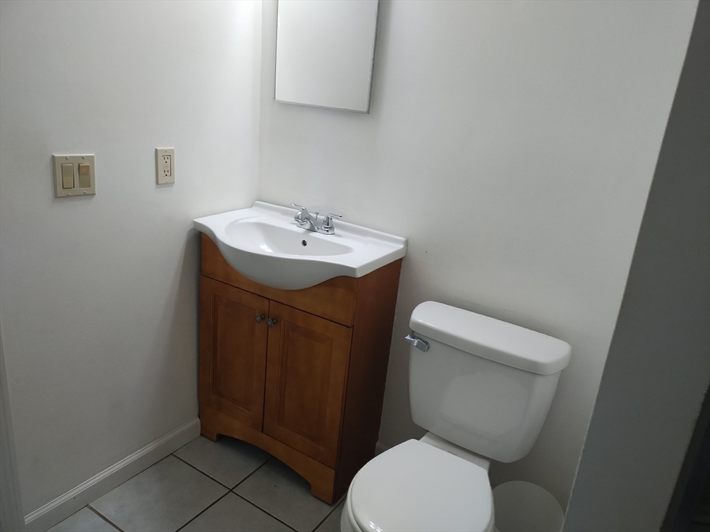 26 Russell Street, Unit AB Hadley, MA 01035 - Photo 38 of 42 a bathroom with a toilet sink and mirror