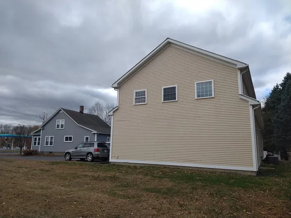 a front view of a house with a street