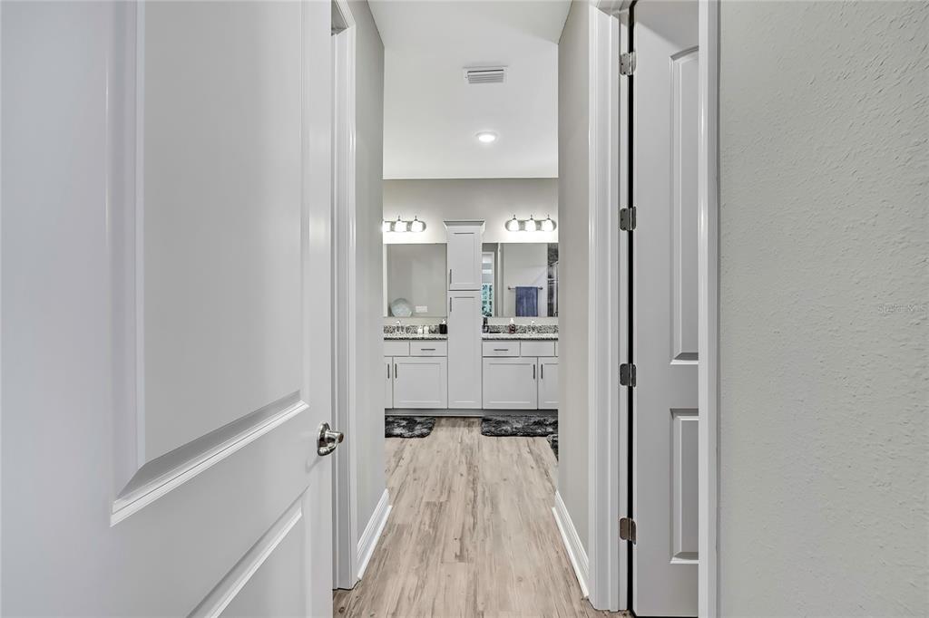 9504 Earthwind Court Weeki Wachee, FL 34613 - Photo 28 of 48 a view of a walk in closet with living room