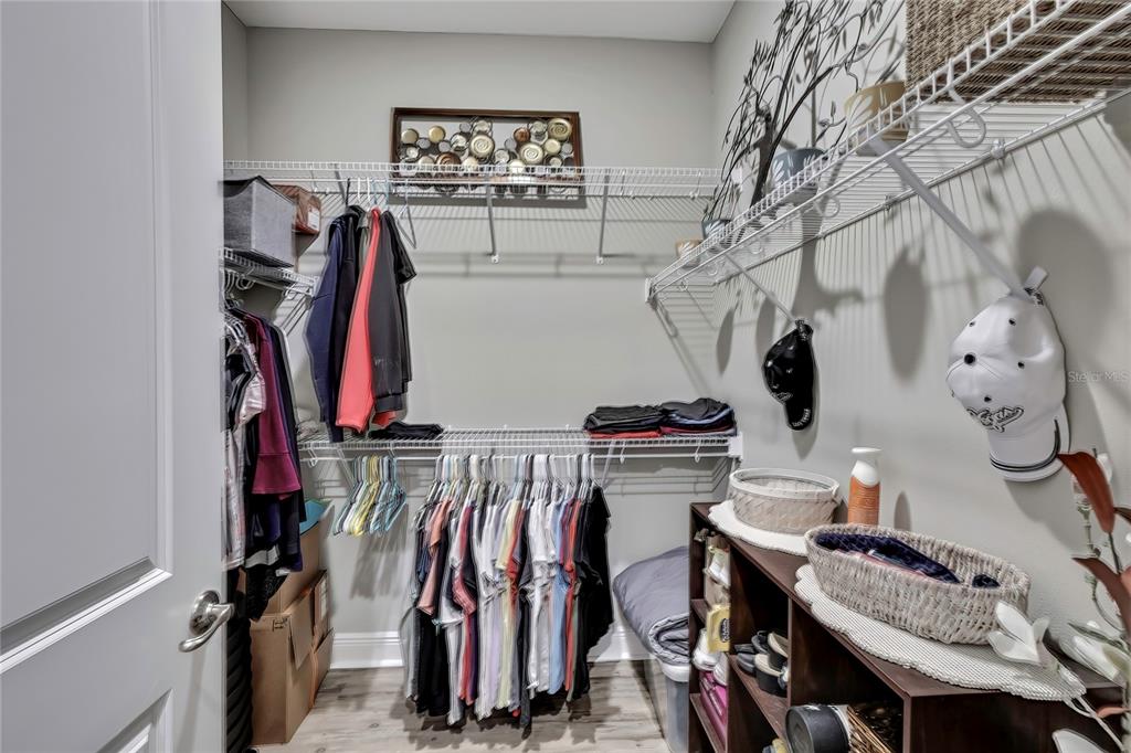 9504 Earthwind Court Weeki Wachee, FL 34613 - Photo 32 of 48 a view of walk in closet with clothes and shoes