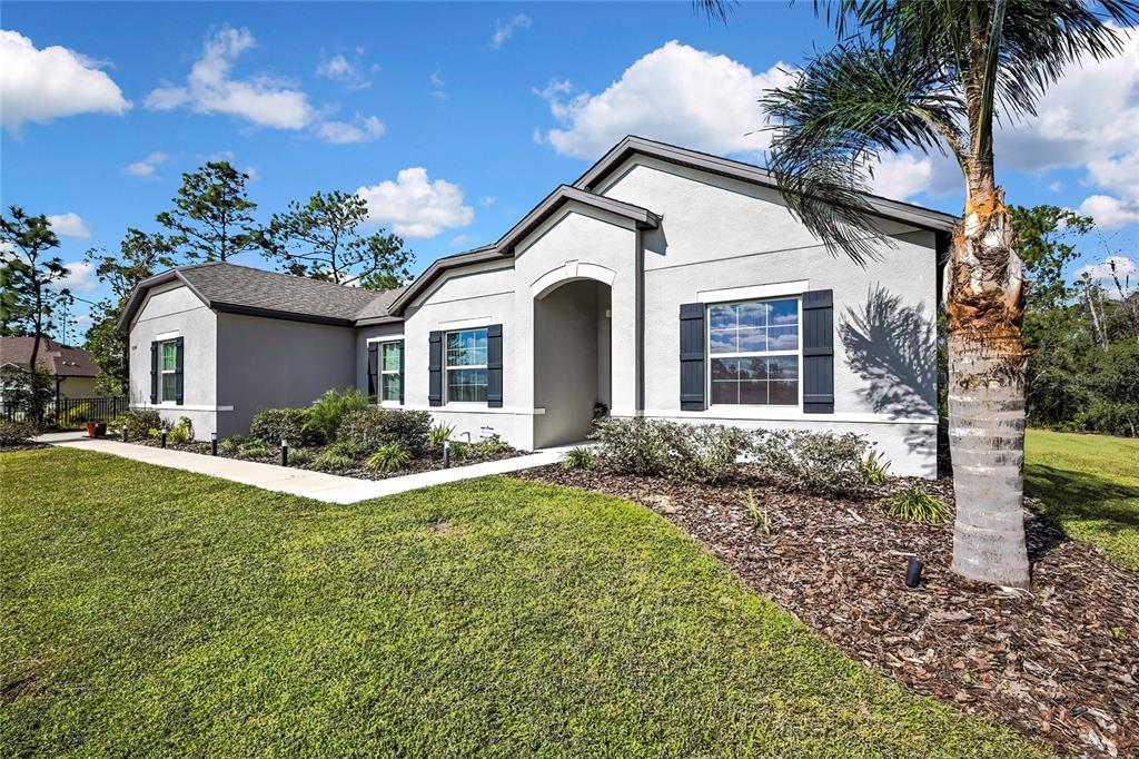 9504 Earthwind Court Weeki Wachee, FL 34613 - Photo 35 of 48 a front view of a house with a garden