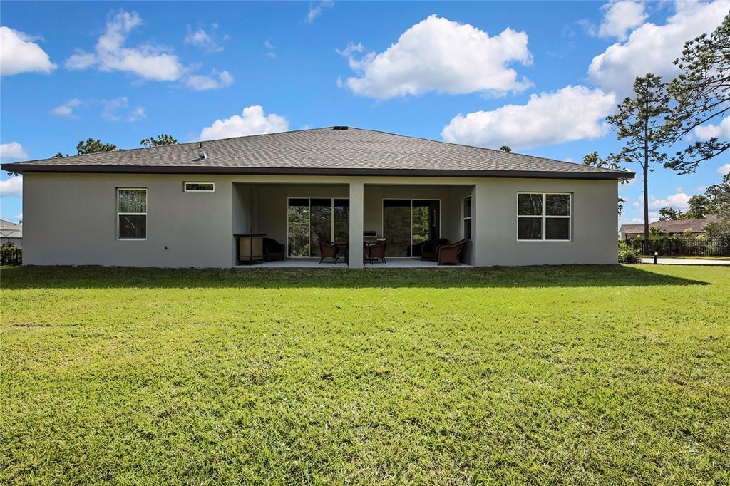 9504 Earthwind Court Weeki Wachee, FL 34613 - Photo 40 of 48 a view of a house with a backyard