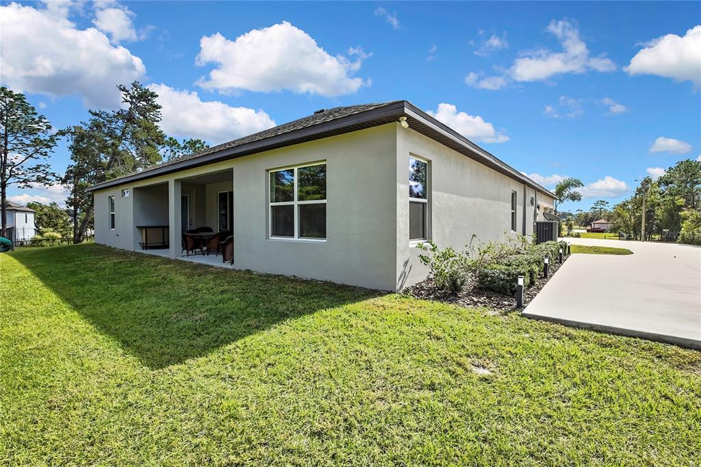 9504 Earthwind Court Weeki Wachee, FL 34613 - Photo 41 of 48 a view of a house with backyard and garden
