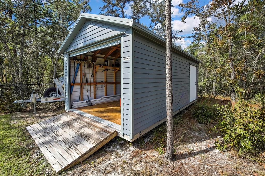 9504 Earthwind Court Weeki Wachee, FL 34613 - Photo 43 of 48 a view of a small house with backyard