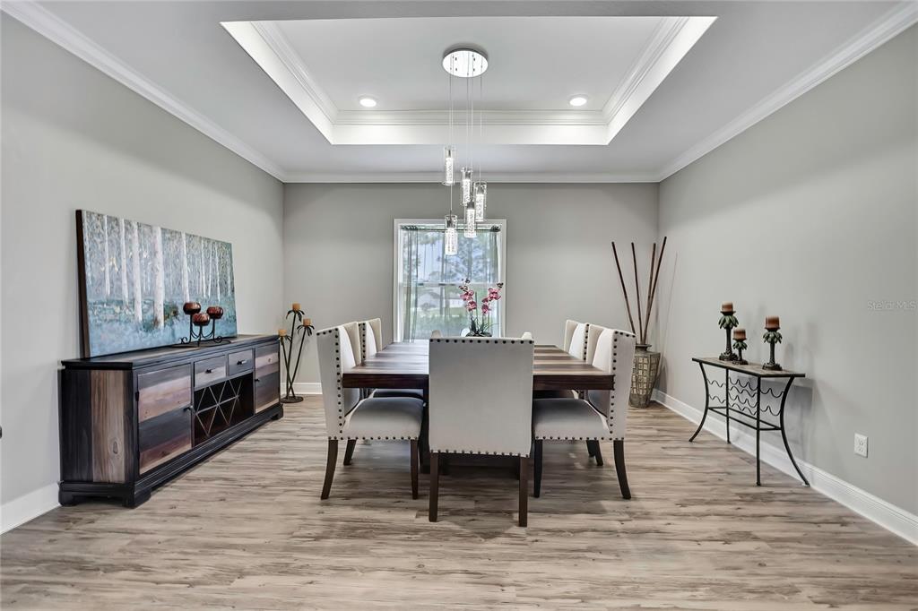 9504 Earthwind Court Weeki Wachee, FL 34613 - Photo 6 of 48 a view of a dining room with furniture and wooden floor