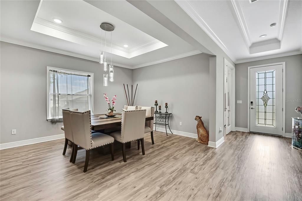 9504 Earthwind Court Weeki Wachee, FL 34613 - Photo 7 of 48 a dining room with furniture window and wooden floor