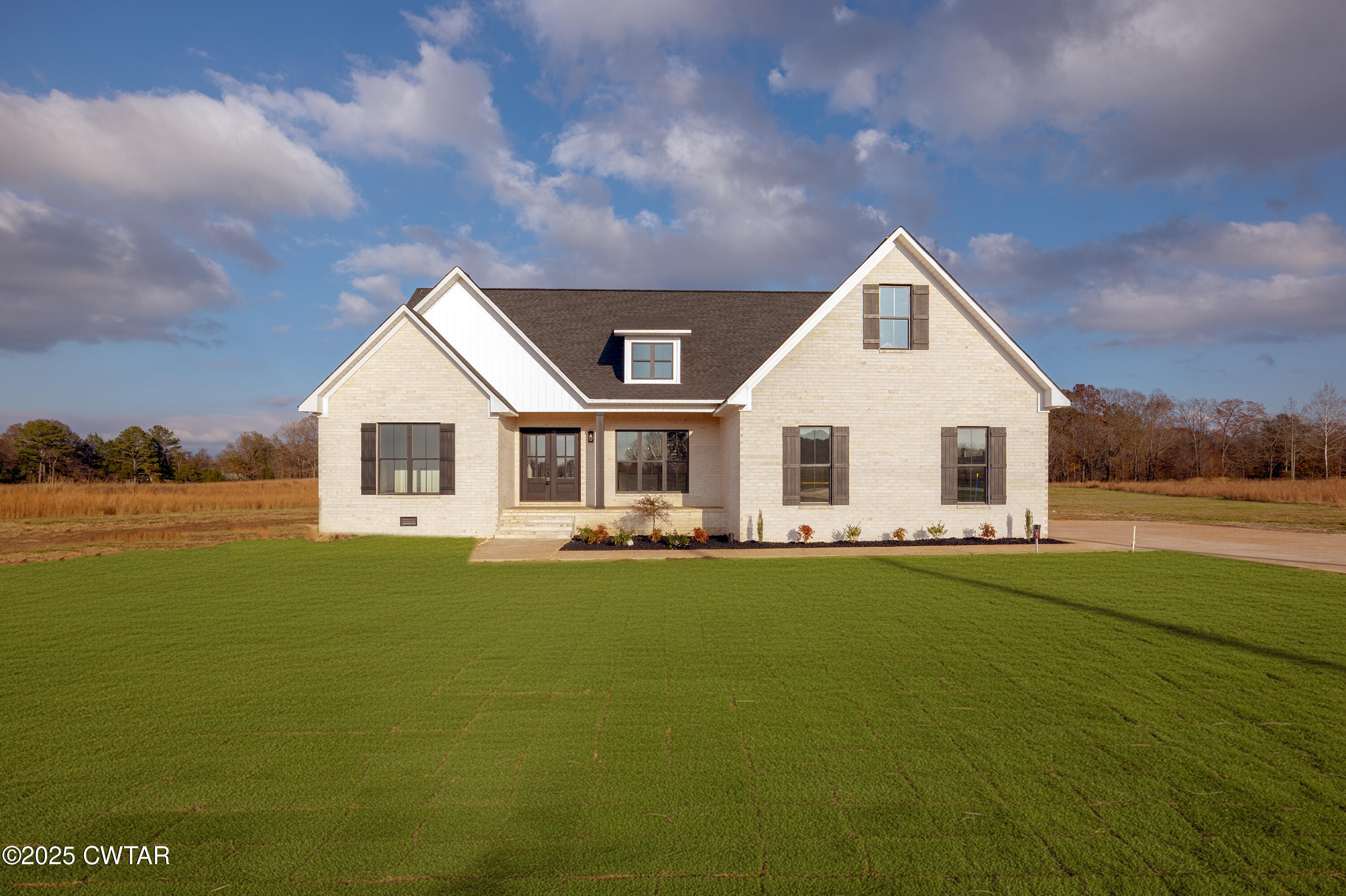 a view of a house with yard and lake view