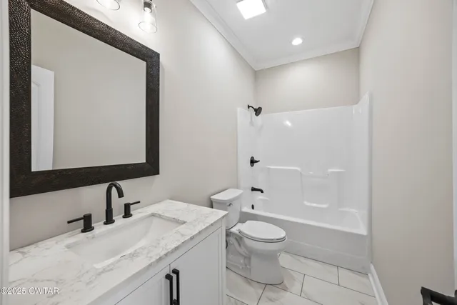 a bathroom with a granite countertop sink a toilet and shower