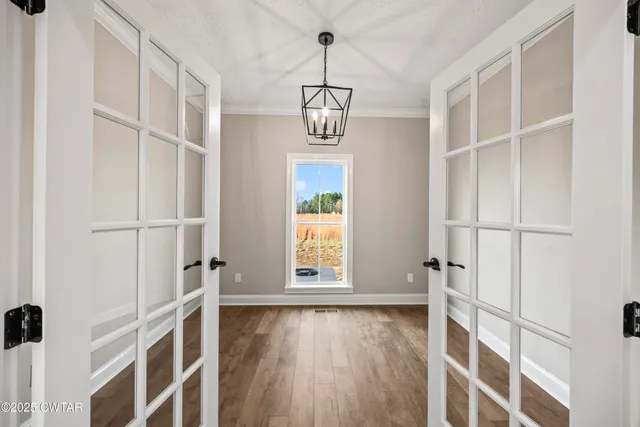 a view of an entryway with wooden floor