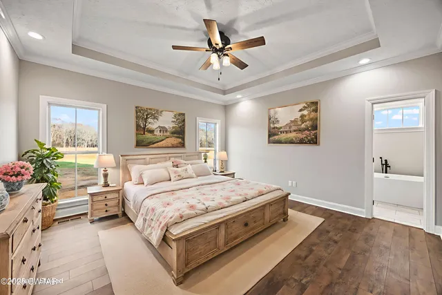 a bedroom with a bed chandelier and a window