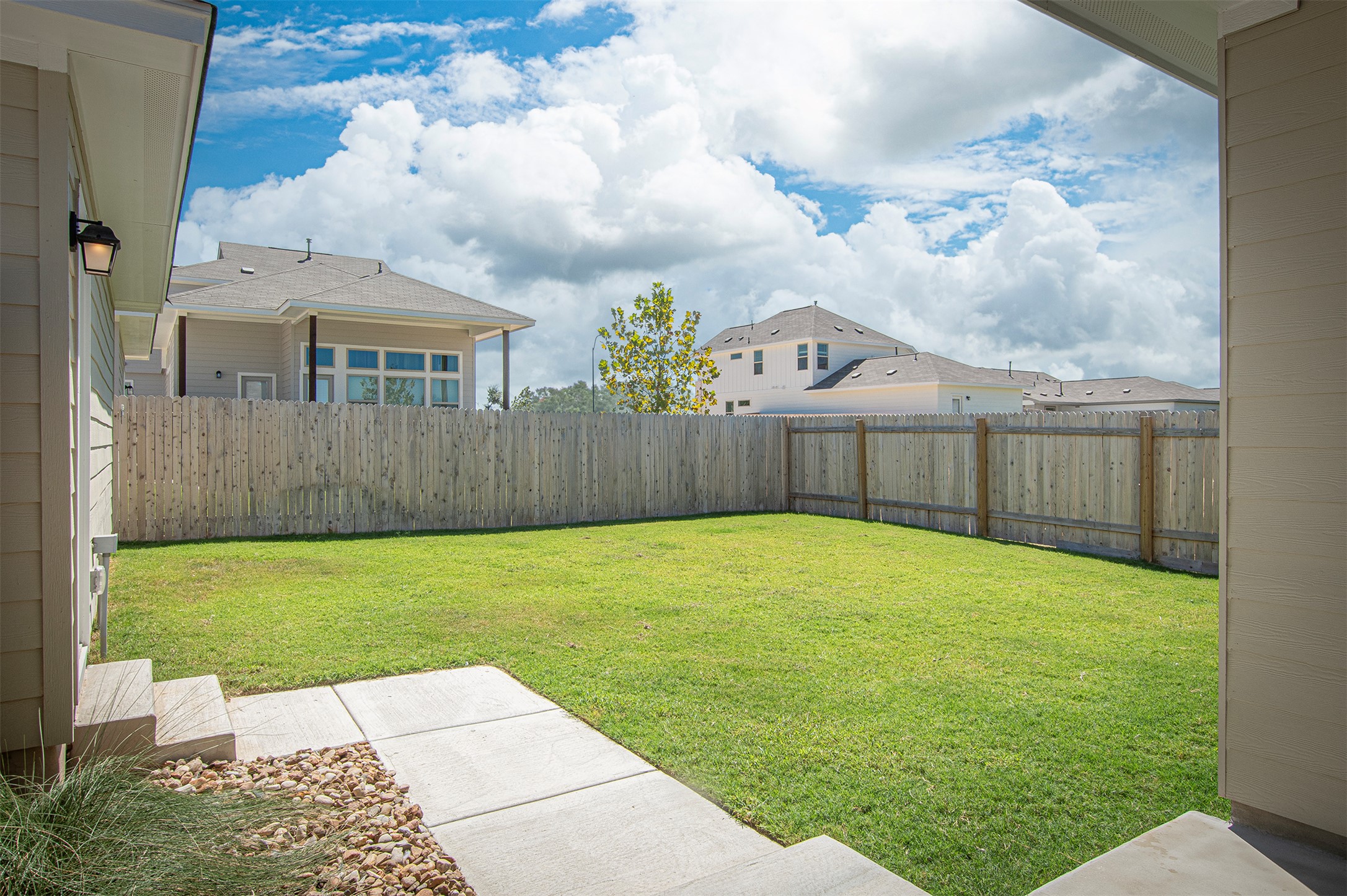 249 Treadwell Lane Kyle, TX 78640 - Photo 24 of 26 a view of a backyard with table and chairs and wooden fence