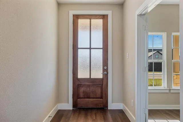 a view of a hallway with wooden floor and cabinet