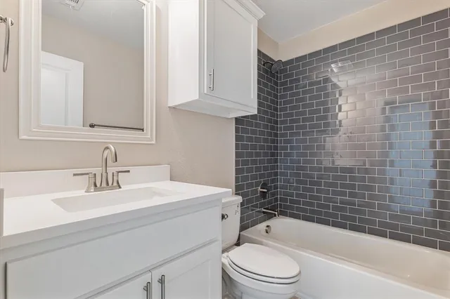 a bathroom with a sink a toilet and bathtub