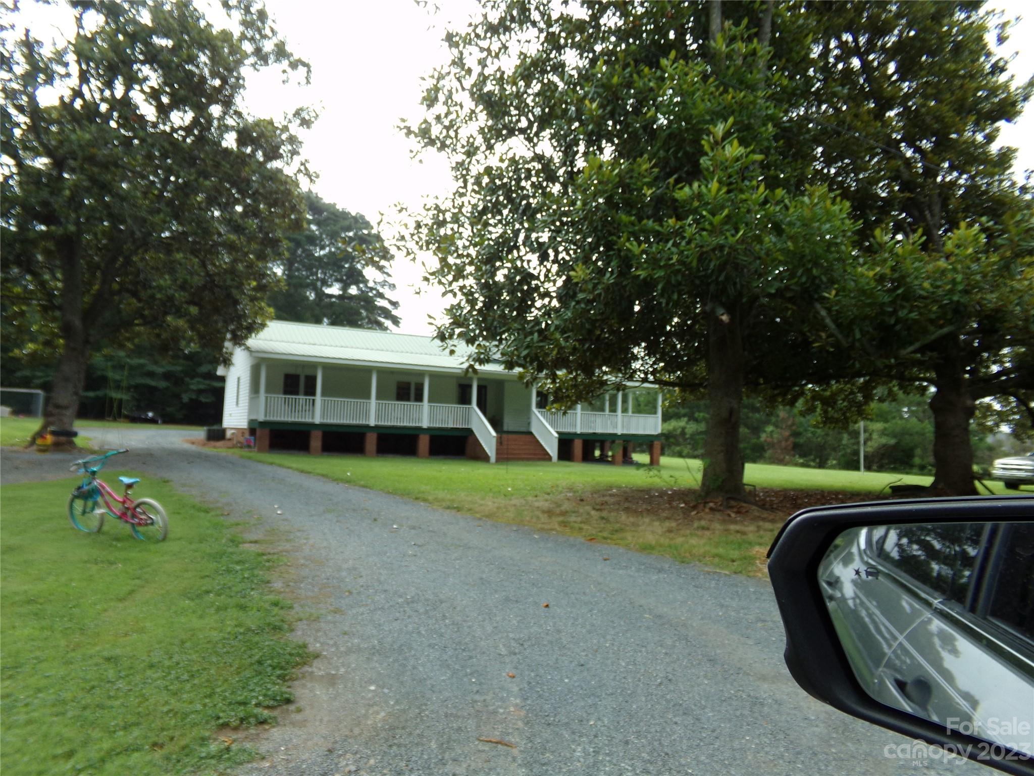 a view of a house with backyard sitting area and garden