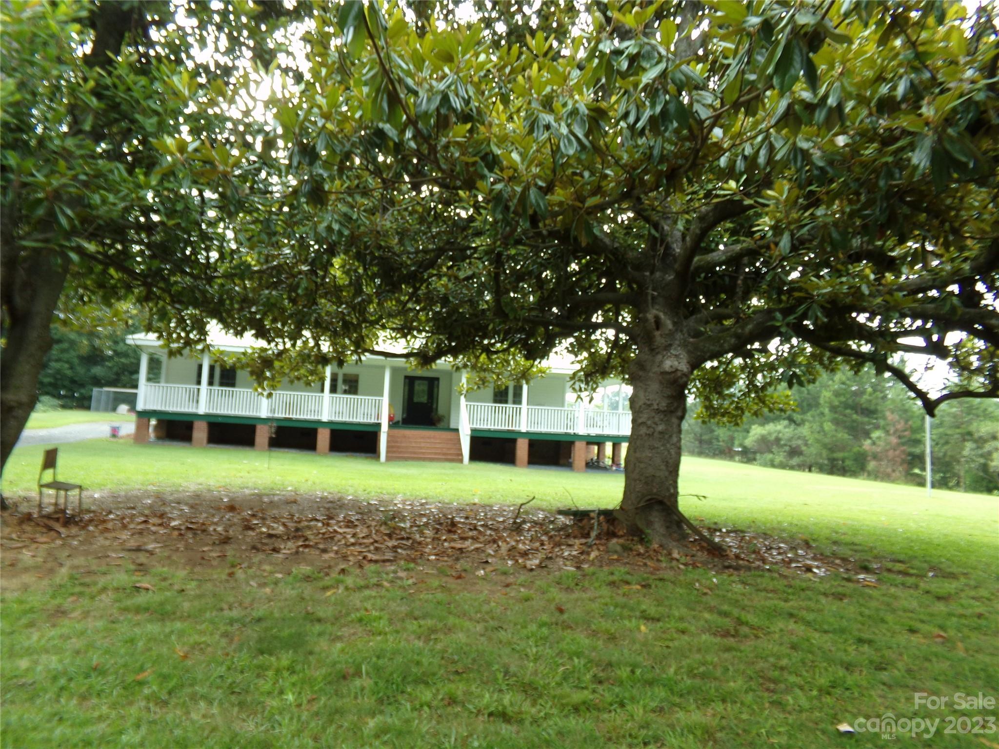 109 Tucker Street Locust, NC 28097 - Photo 2 of 13 a view of a house with a yard