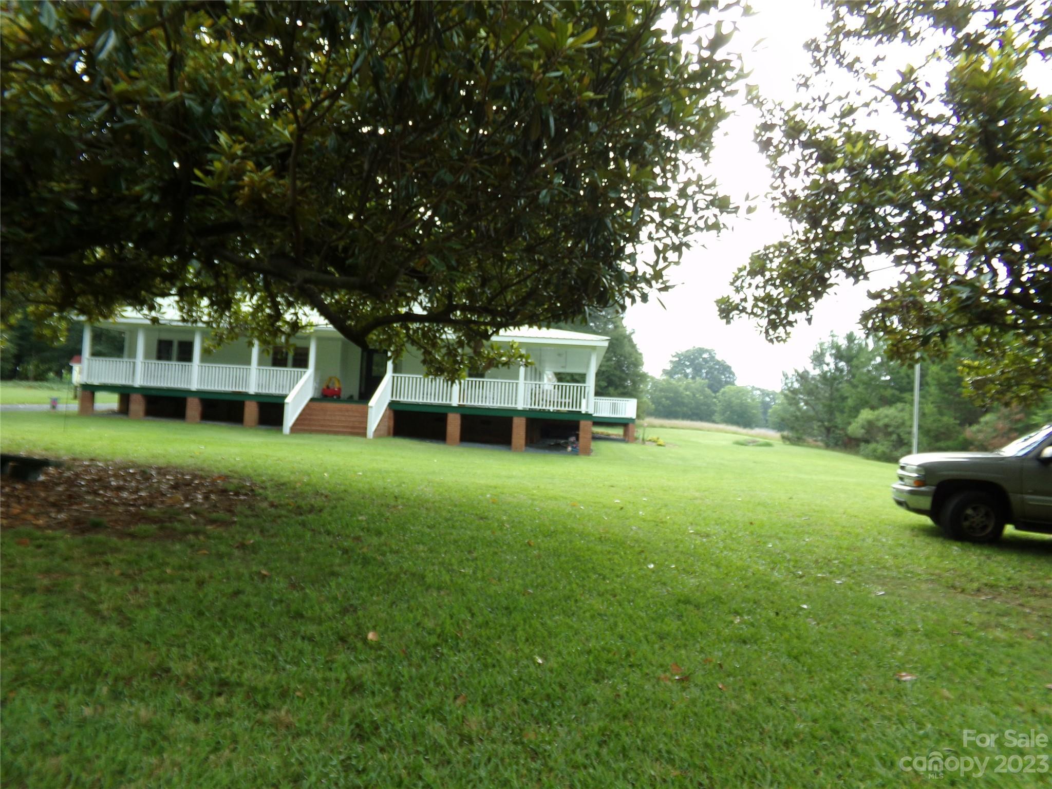 109 Tucker Street Locust, NC 28097 - Photo 3 of 13 a view of a house with a yard